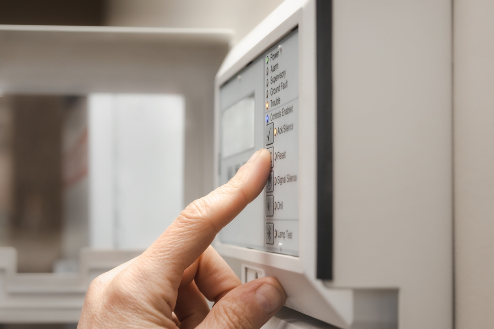 Fire,alarm,technician,using,the,fire,alarm,control,panel,or