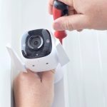 Surveillance,camera,in,male,hands.,installing,a,cctv,camera,for